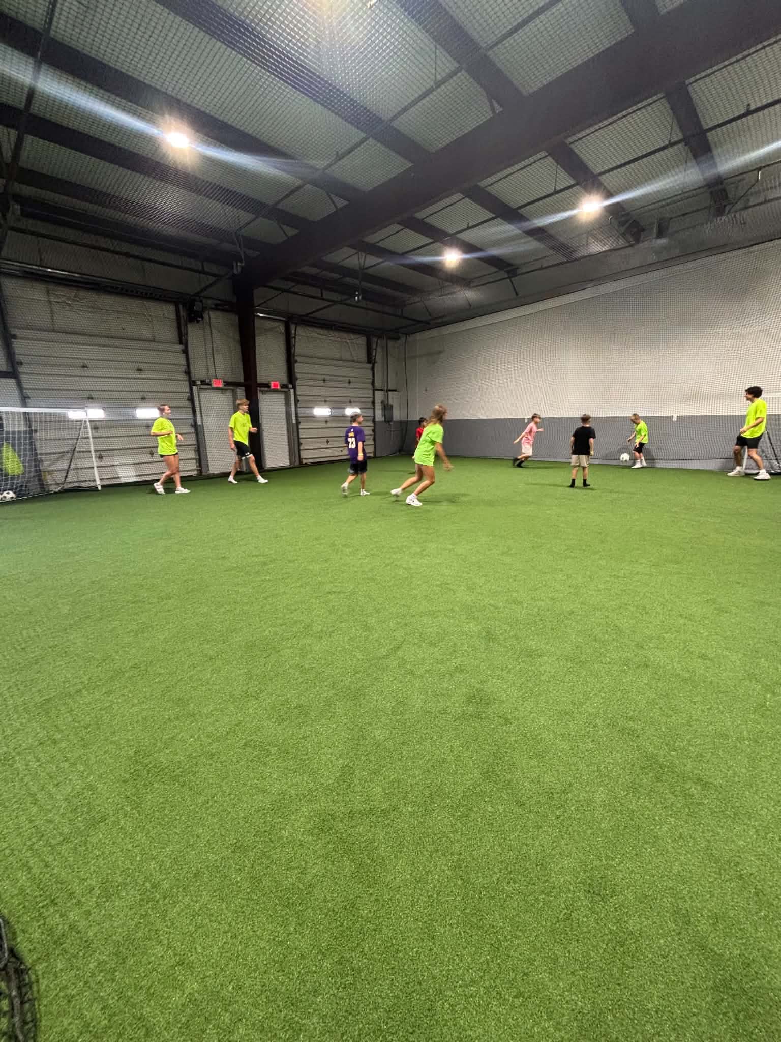 Young players taking part in a soccer game on the indoor field